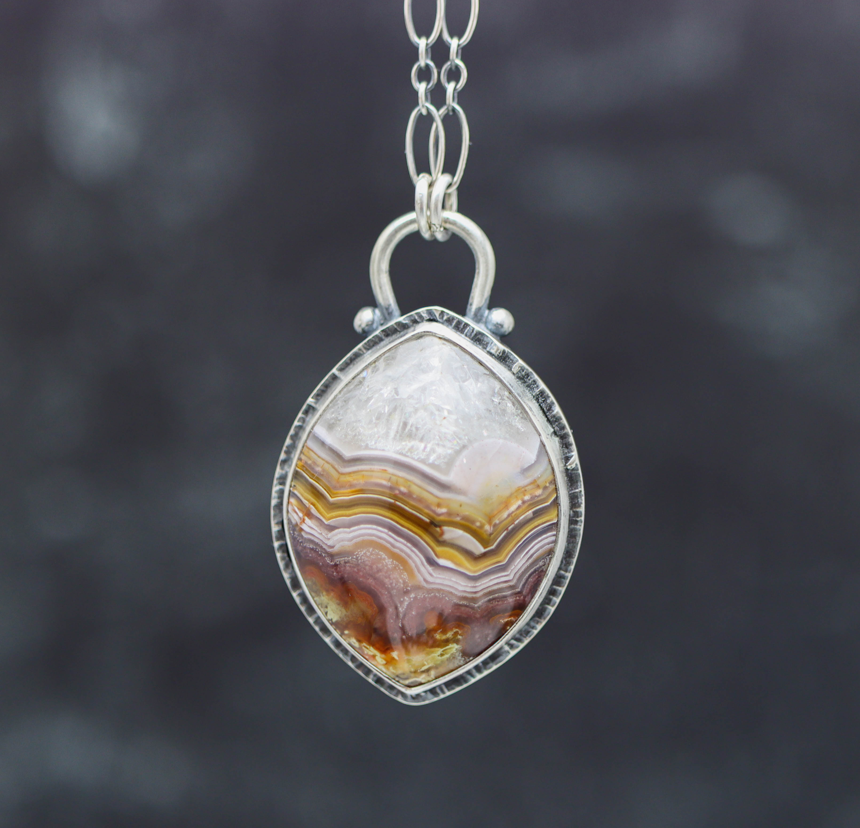Agate pendant necklace on a dark background