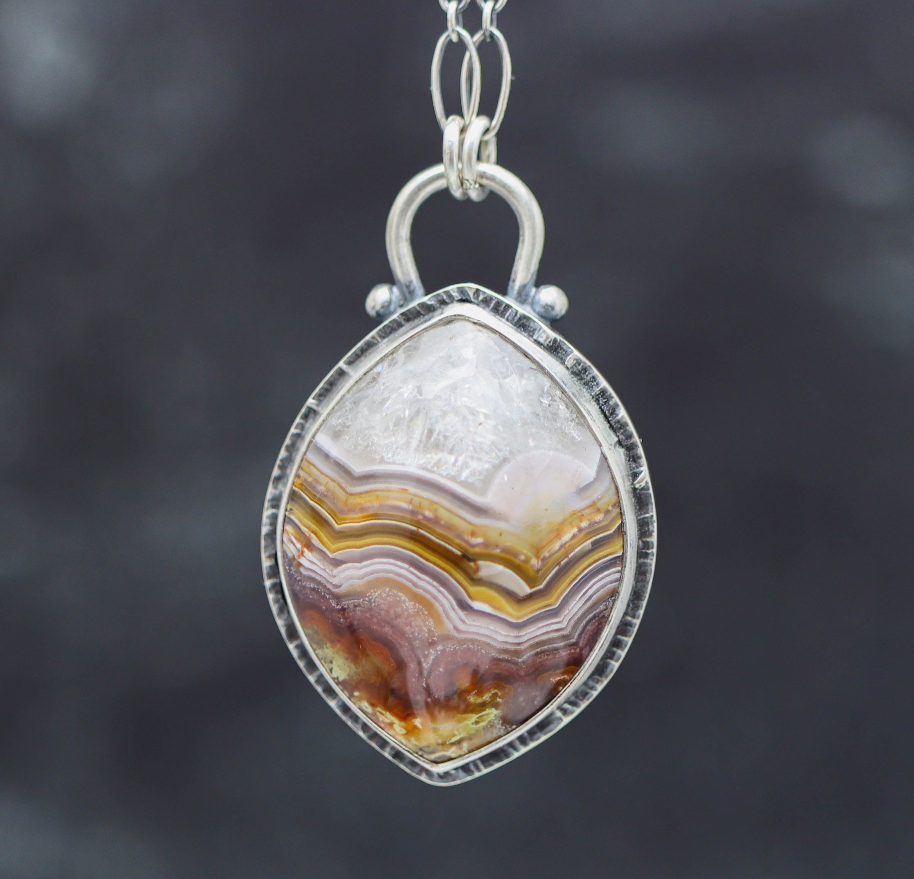 Agate pendant necklace on a dark background